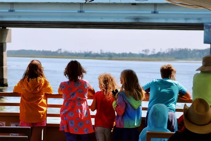 a group of people standing in front of a body of water