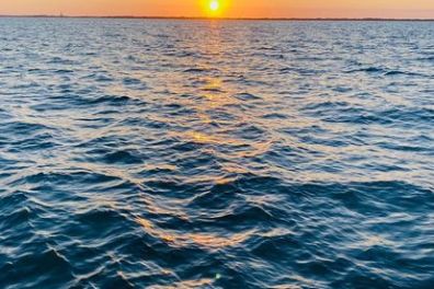 a sunset over a body of water