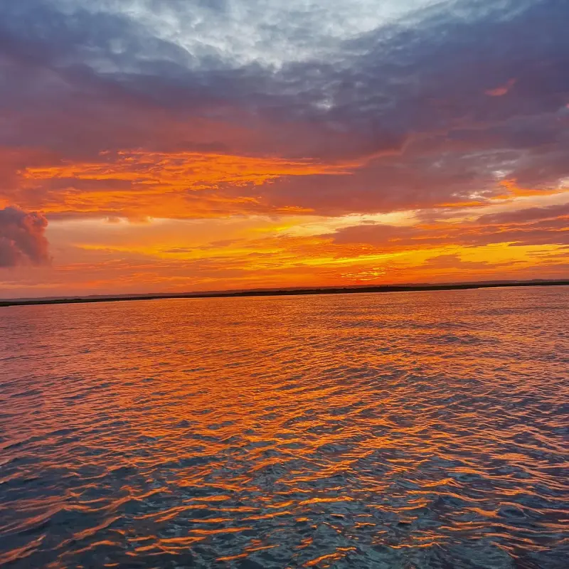 a sunset over a body of water
